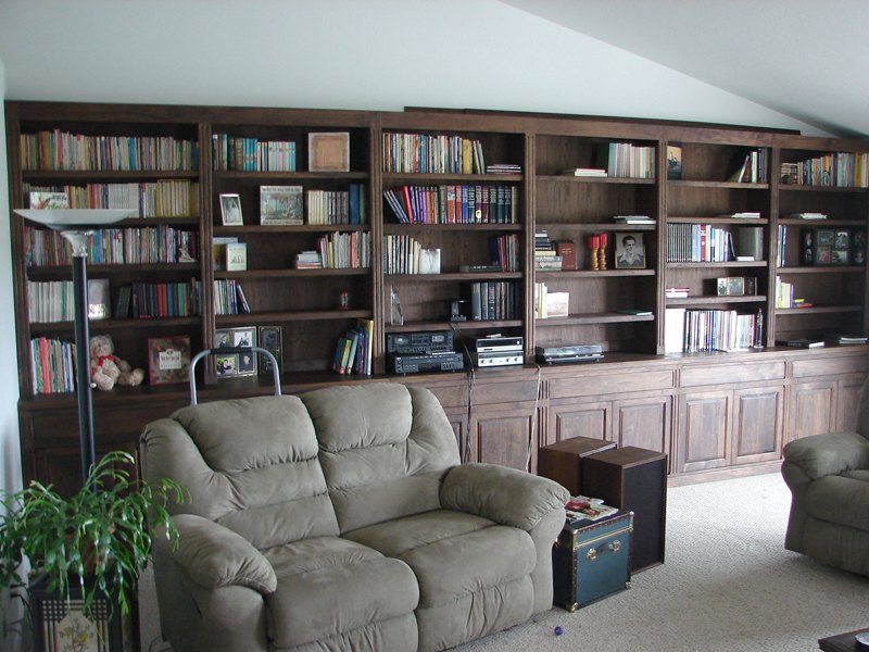 Wall-length walnut bookcase and credenza in a living room